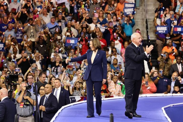 Kamala Harris Tim Walz greet the crowd at the rally