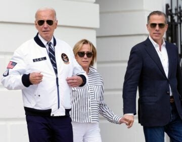 President Joe Biden, from left, walking with his sister Valerie Biden Owens and his son Hunter Biden, shows off his Team USA jacket as he walks toward Marine One on the South Lawn of the White House in Washington, Friday, July 26, 2024, en route to Camp David for the weekend. (AP Photo/Susan Walsh)