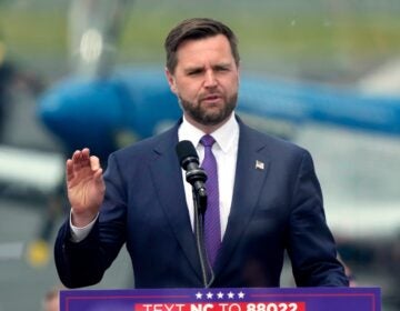 JD Vance speaks behind a podium