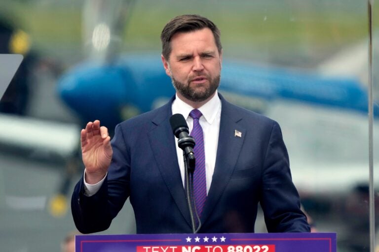 JD Vance speaks behind a podium