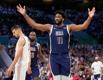 Joel Embiid with his hands up