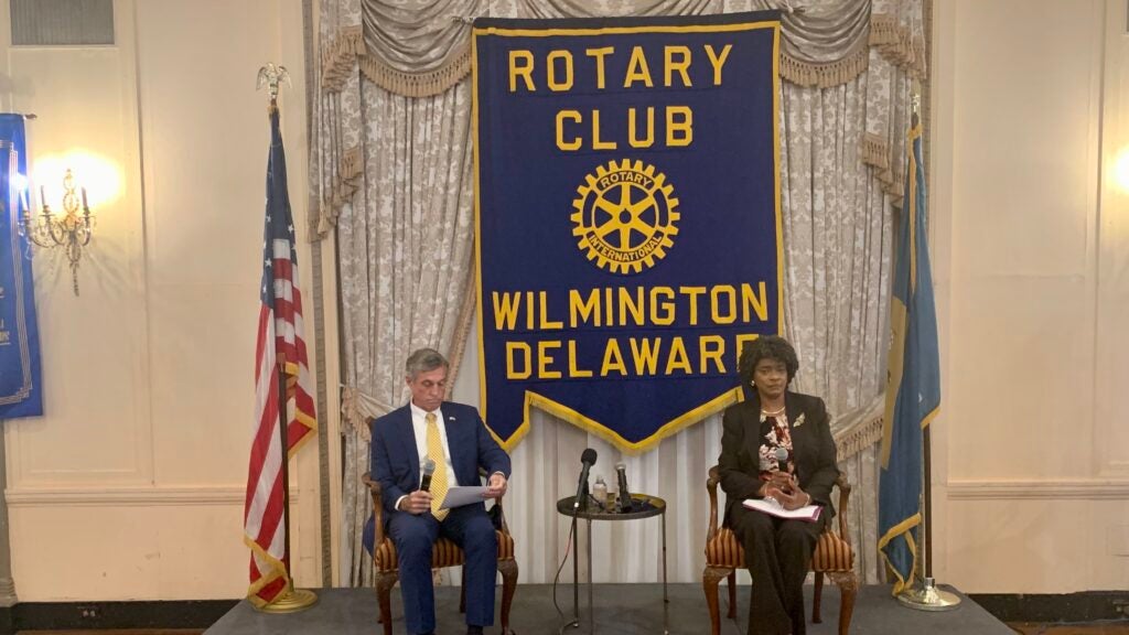 John Carney and Velda Jones-Potter sit in a debate