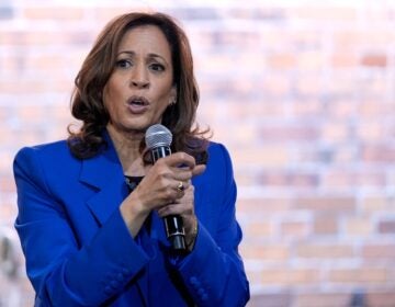 Kamala Harris holds a microphone