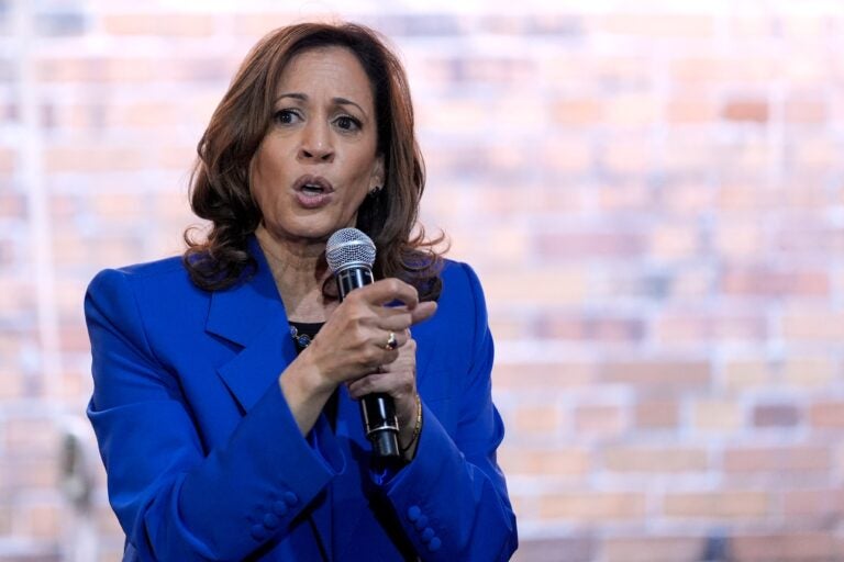 Kamala Harris holds a microphone