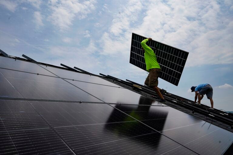 A crew installs a solar array on the roof of a home in Frankfort, Ky., in 2023.