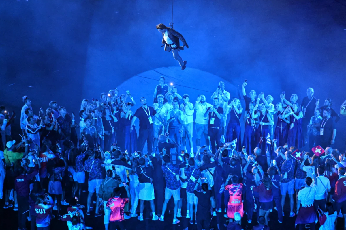 Actor Tom Cruise descends from the roof of the stadium on Sunday.