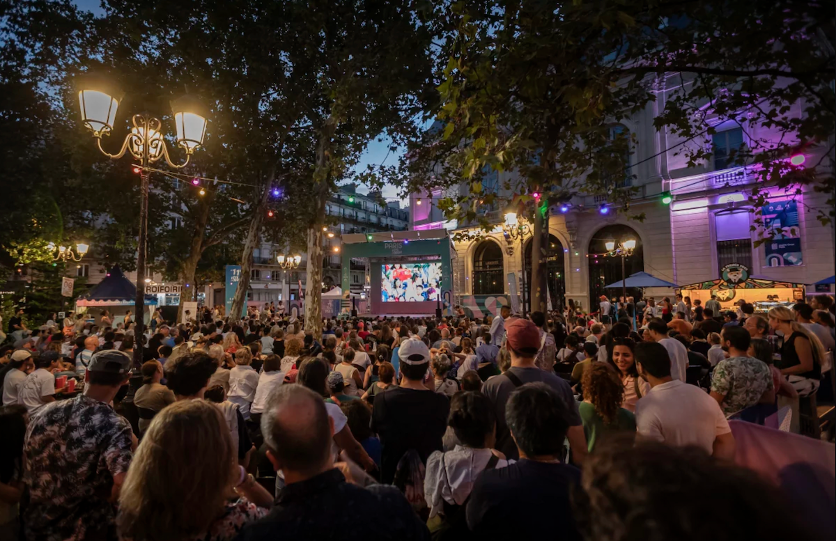 People watch a TV program airing the 2024 Summer Olympics closing ceremony on Sunday.