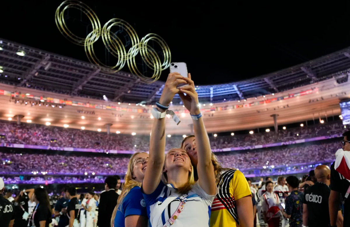 Athletes pose for a selfie on Monday at the Olympics.