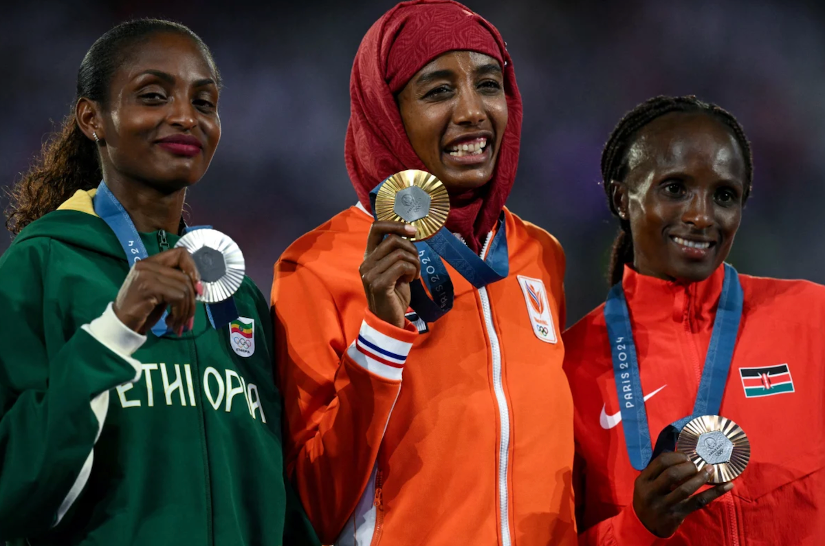 Silver medal winner, Ethiopia's Tigst Assefa, gold medalist Netherlands' Sifan Hassan and bronze medalist Kenya's Hellen Obiri pose during the podium ceremony for the women's marathon event on Sunday.