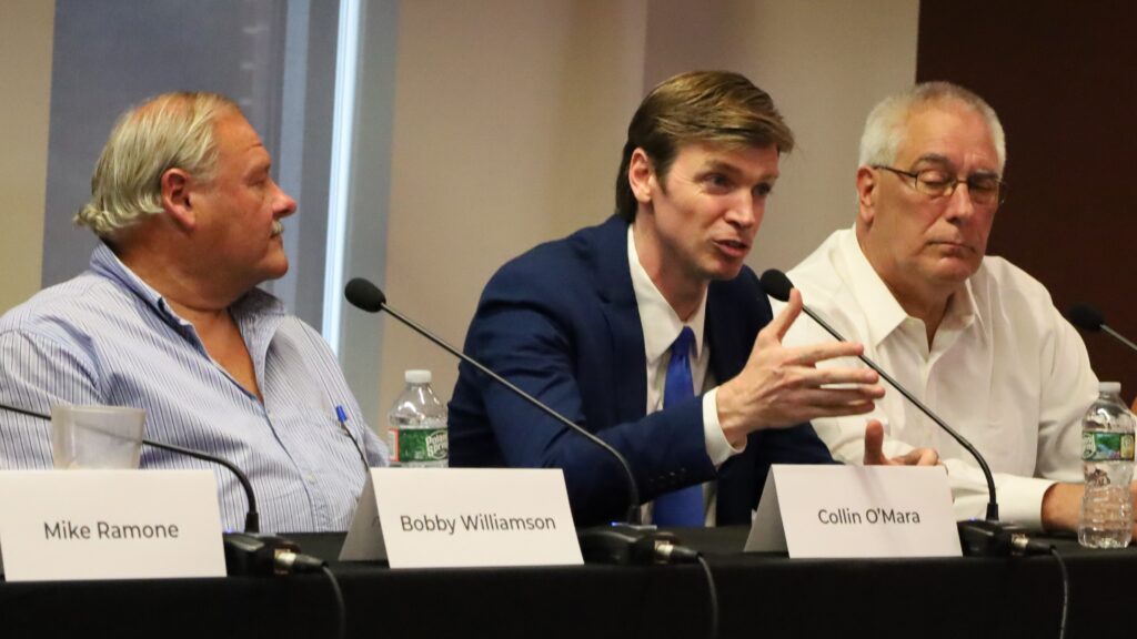 Bobby Williamson and Jerry Price listen to Collin O'Mara speak