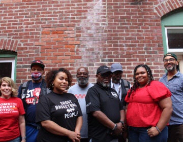 Several people advocating against gun violence pose for a photo at WHYY's Bridging Blocks event August 17.