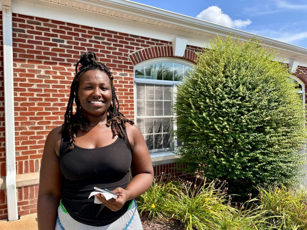 Mother Jalisa Brim stands outside a building in Seaford