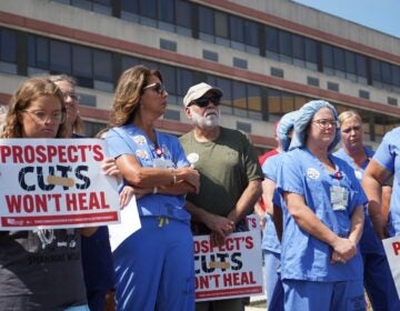 Lisa Konialian and other nurses stand, some holding signs reading PROSPECT'S CUTS WON'T HEAL