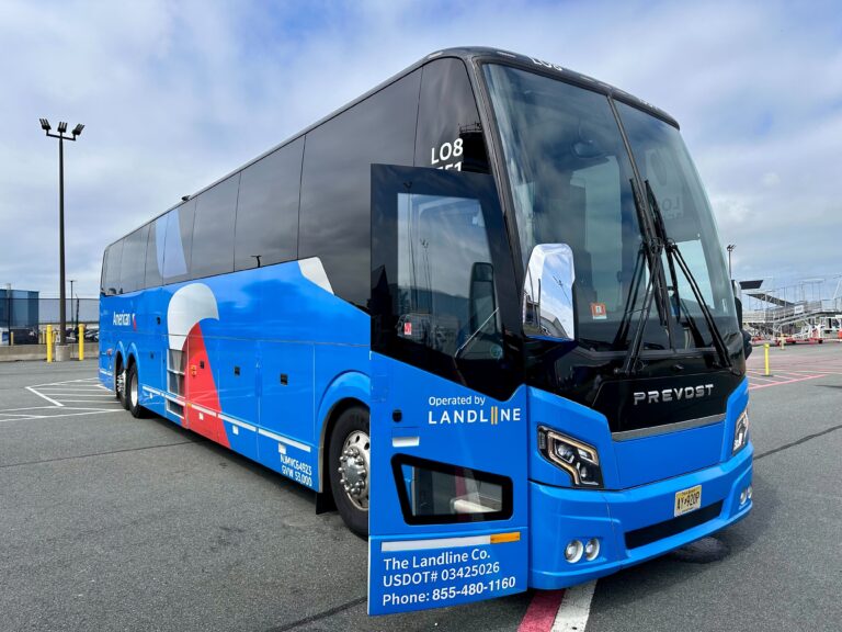 a motor coach sits in a parking lot