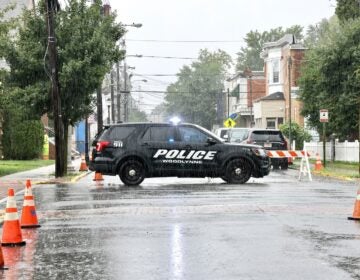 A Woodlynne Police Department cruiser is seen in the rain