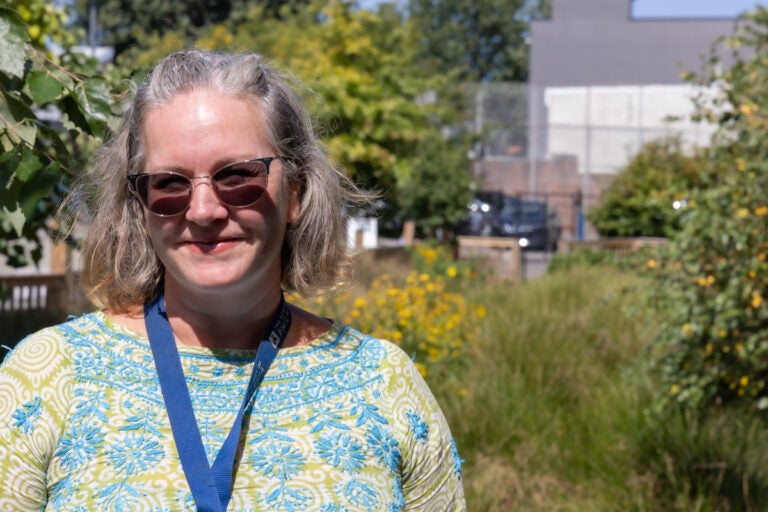 Emma-Lynn Melvin smiles in the rain garden