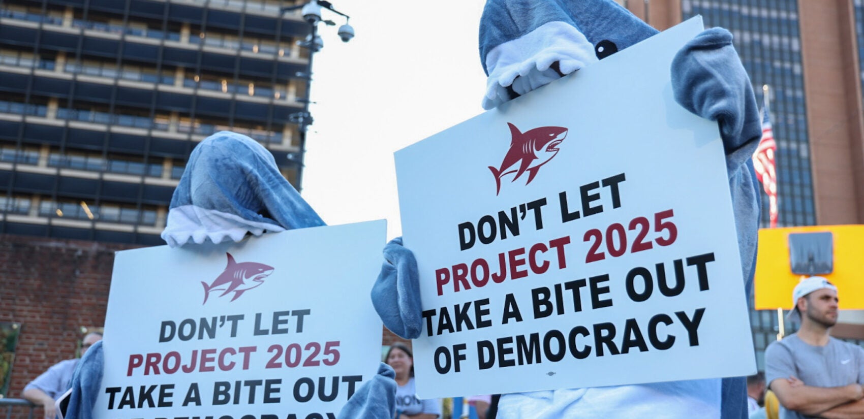 protesters in shark costumes