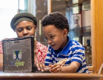 Austen, 6, works his way through an online class with the help of his mother, Constance. Constance decided to homeschool Austen who has autism due to a lack of support by local public schools. (Kimberly Paynter/WHYY)