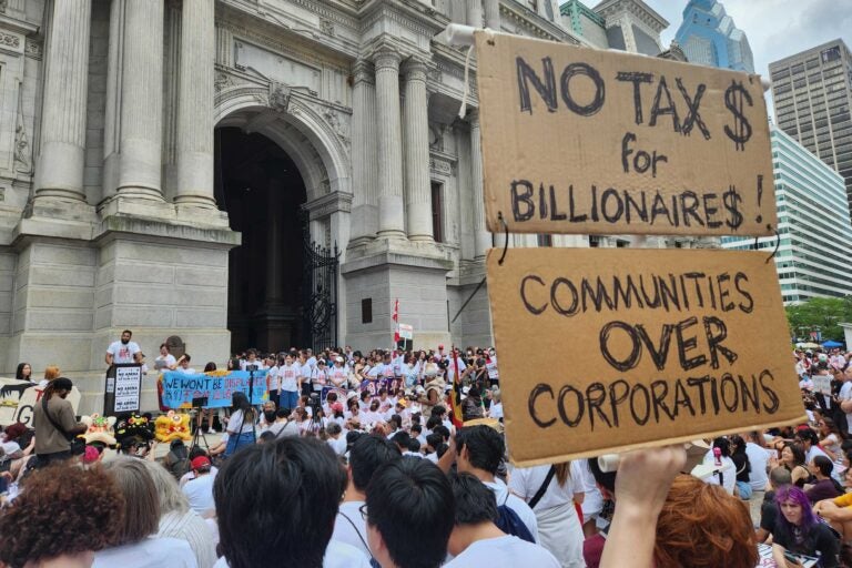 A person holds signs reading 