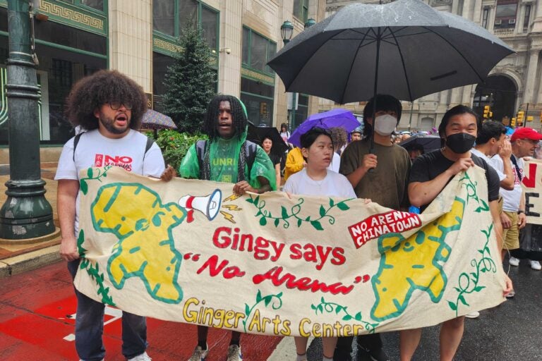 Protestors hold a sign that reads 