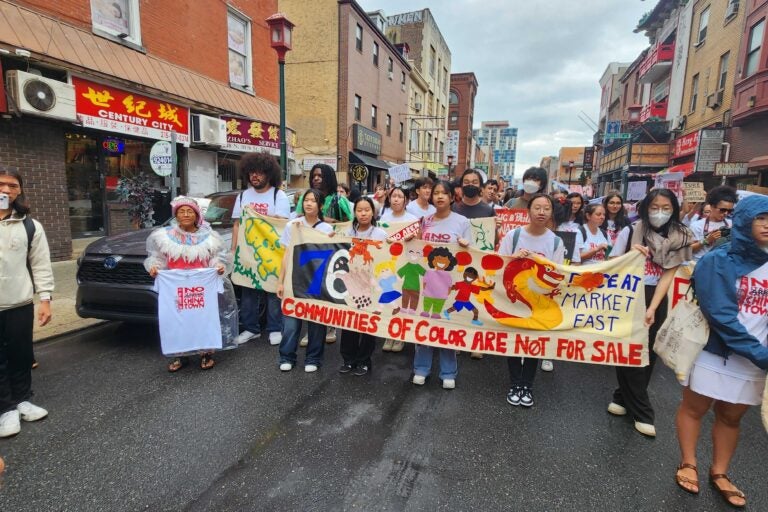 People holding a sign reading 