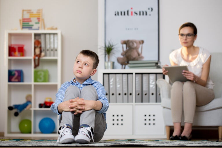 Psychologist is looking at a child with autism spectrum disorder. (Bigstock/Kasia Bialasiewicz)