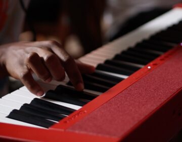 At Beyond the Bars, a community based and student-driven music program in Philadelphia, a student plays the keyboard. (Miguel Perez/WHYY)