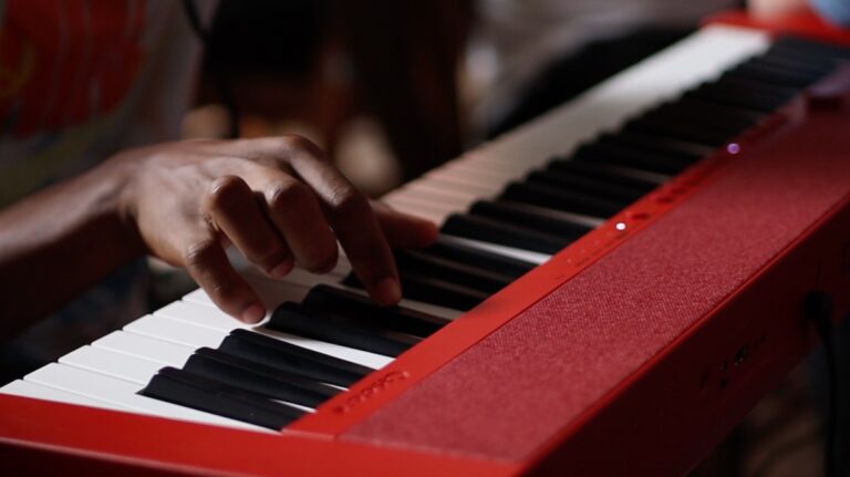 At Beyond the Bars, a community based and student-driven music program in Philadelphia, a student plays the keyboard. (Miguel Perez/WHYY)