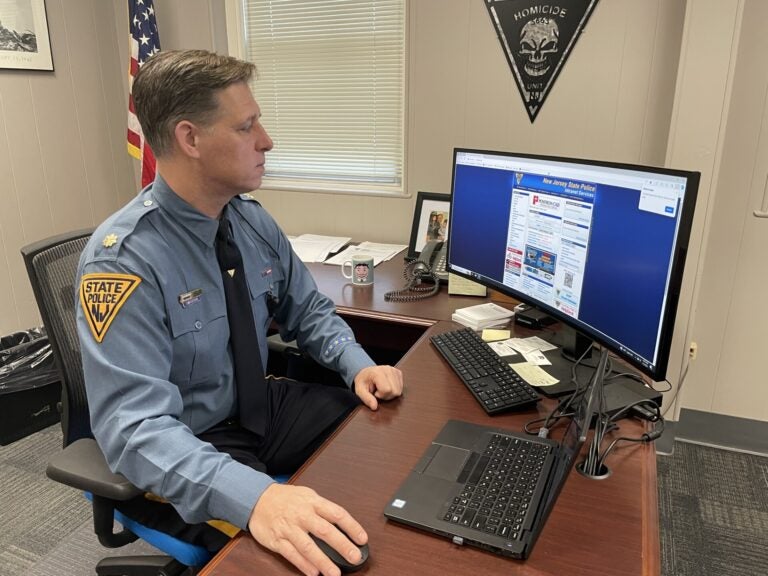 New Jersey State Police Major Tom Wieczerak sits at a desk working on a computer