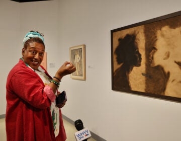 CCH Pounder in front of an art piece