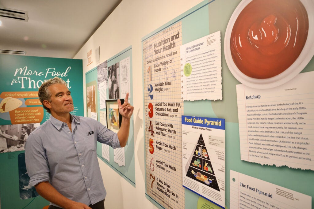 Jesse Smith points at a guide on the wall