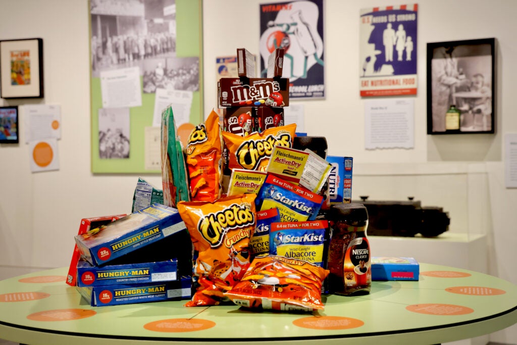 a stack of Cheetos, StarKist tuna and other snacks piled on top of each other, on display