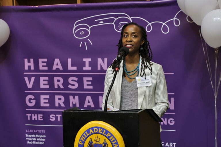 Marguerite Anglin speaking at a podium