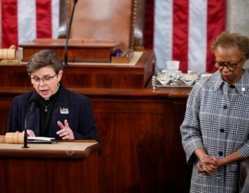 House Chaplain retired Rear Adm. Margaret Kibben offers a prayer as Clerk of the House of the Representatives Cheryl Johnson bows her head in the House chamber as the House meets for the fourth day to elect a speaker and convene the 118th Congress in Washington, Friday, Jan. 6, 2023. (AP Photo/Andrew Harnik)