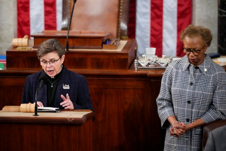 House Chaplain retired Rear Adm. Margaret Kibben offers a prayer as Clerk of the House of the Representatives Cheryl Johnson bows her head in the House chamber as the House meets for the fourth day to elect a speaker and convene the 118th Congress in Washington, Friday, Jan. 6, 2023. (AP Photo/Andrew Harnik)