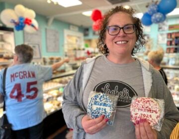 Kathleen Lochel holding up sugar cookies