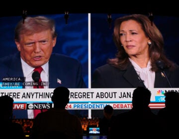 People watching the presidential debate on a large screen