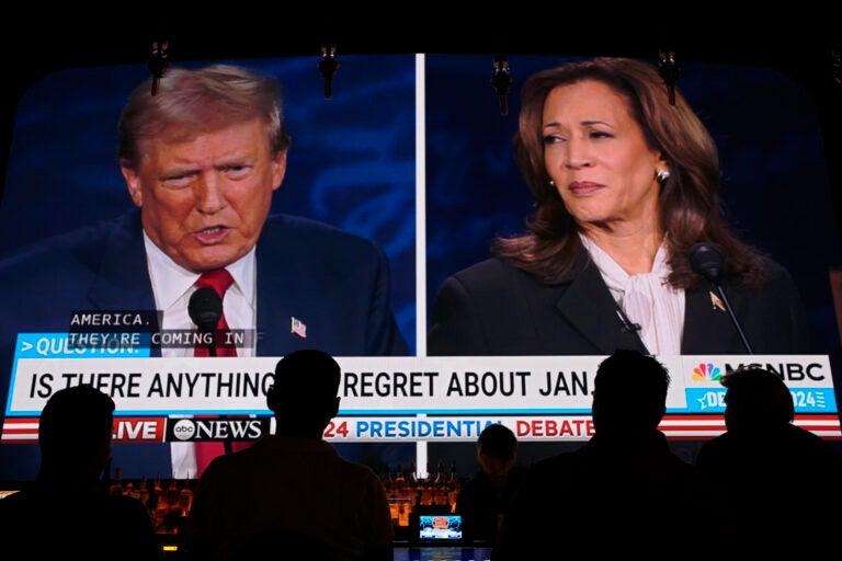 People watching the presidential debate on a large screen