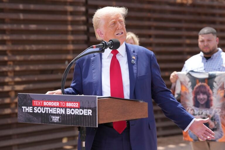 Donald Trump speaking at a podium