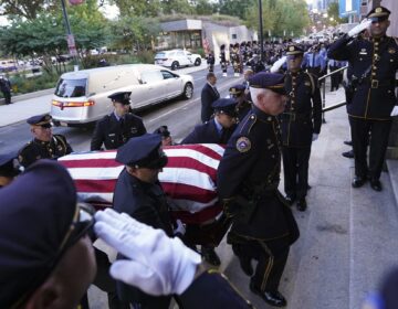 Officers carry the casket