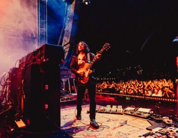 Adam Granduciel playing guitar onstage