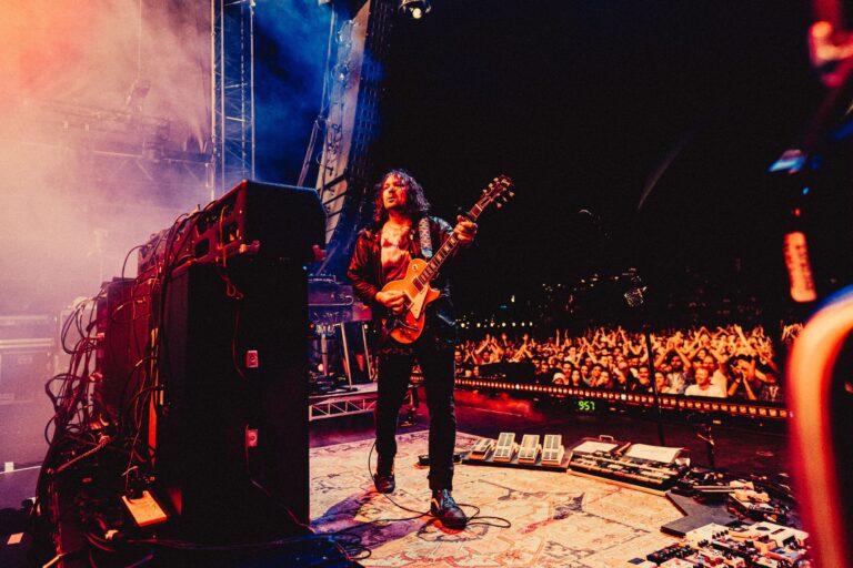 Adam Granduciel playing guitar onstage