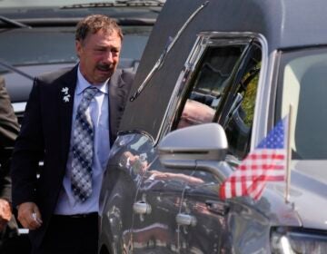 Guy Gaudreau looks into a hearse