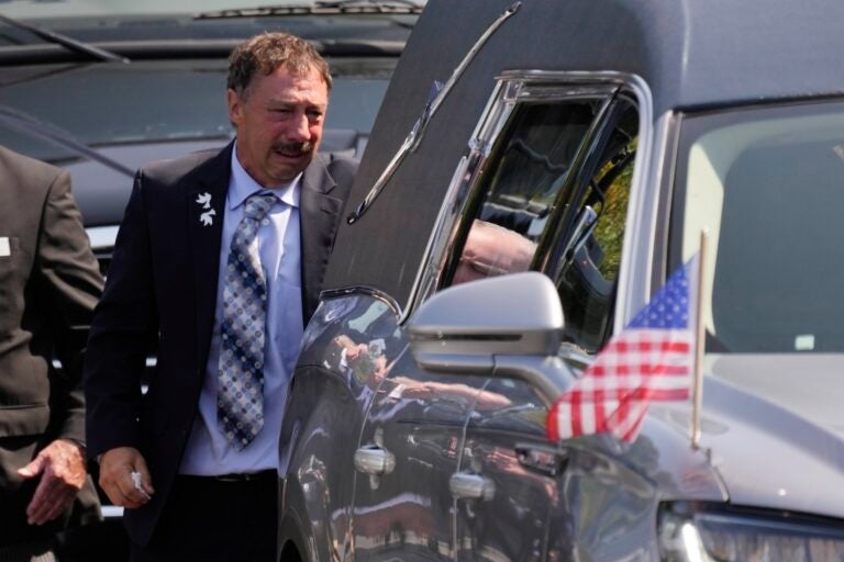 Guy Gaudreau looks into a hearse