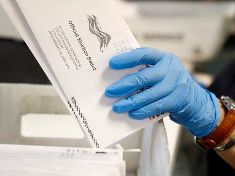 Worker processes mail-in ballots