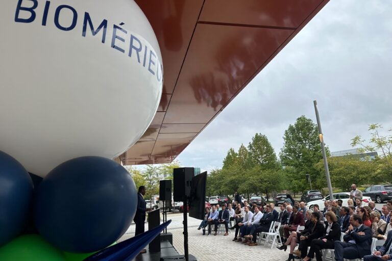 a crowd of people in front of a sign for bioMérieux