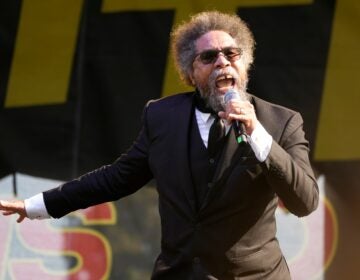 Cornel West speaks into a microphone