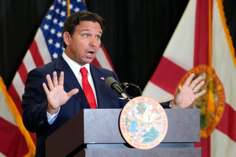 Ron DeSantis speaks behind a podium