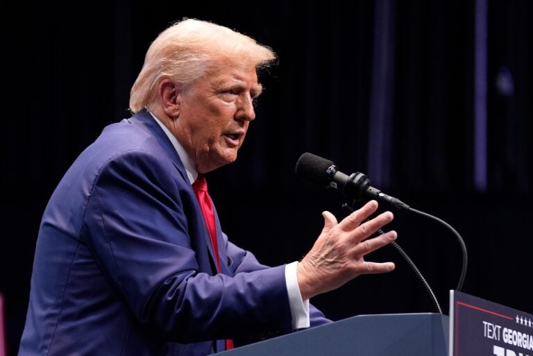 Donald Trump speaks behind a podium