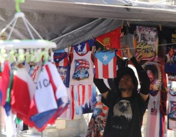 a person hangs t-shirts